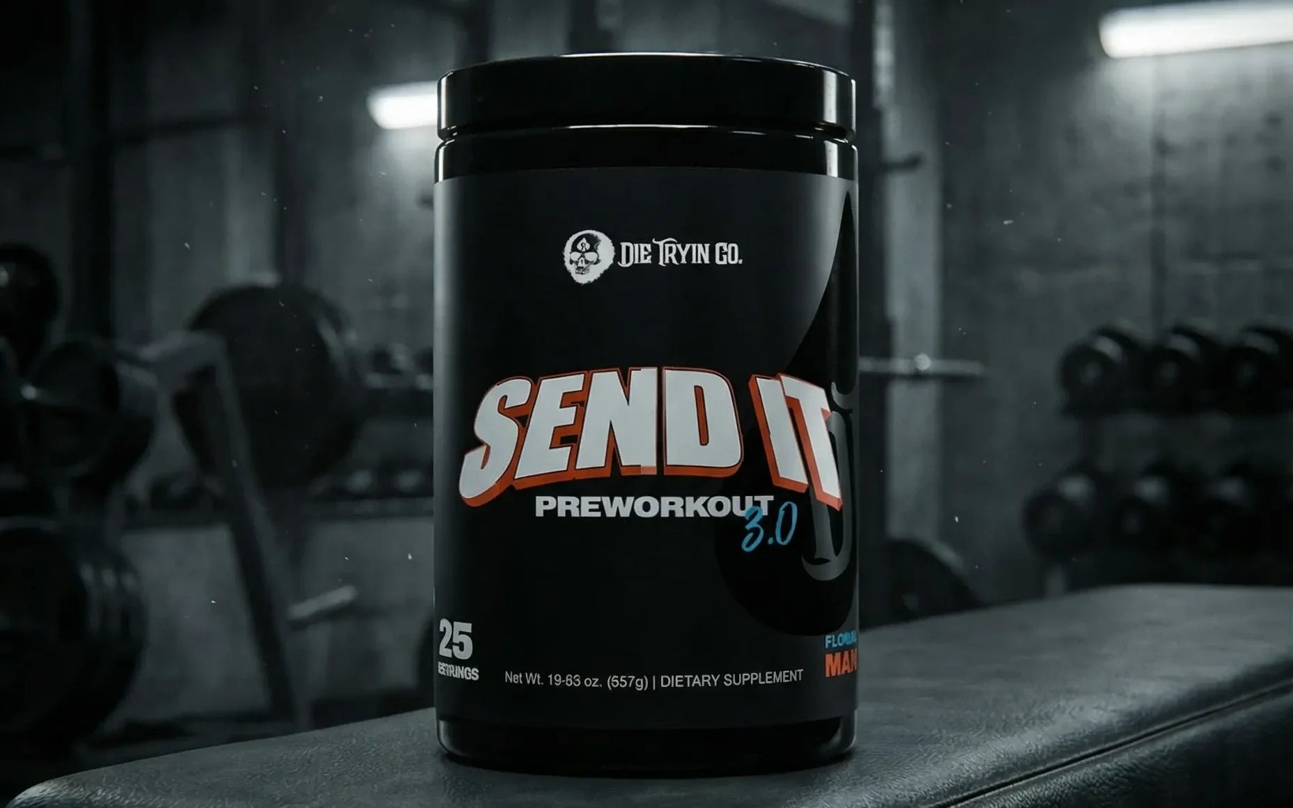 Black container of SEND IT V3 supplement on a weight bench in a gym.